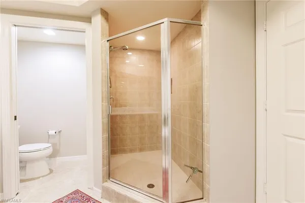 a bathroom with a glass shower door