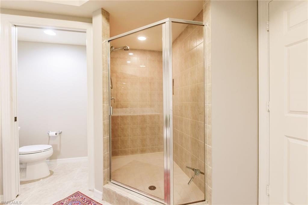 1065 Borghese Lane, Unit 1003 Naples, FL 34114 - Photo 19 of 43 a bathroom with a glass shower door