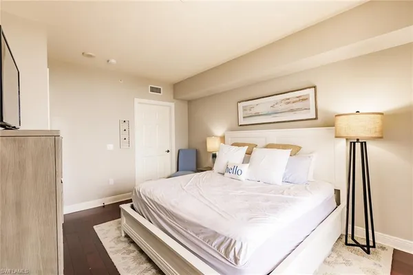 a bedroom with a bed and a night stand