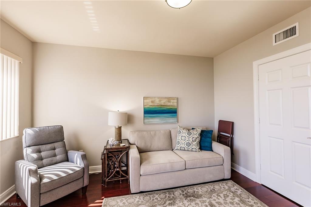 1065 Borghese Lane, Unit 1003 Naples, FL 34114 - Photo 24 of 43 a living room with furniture and a window