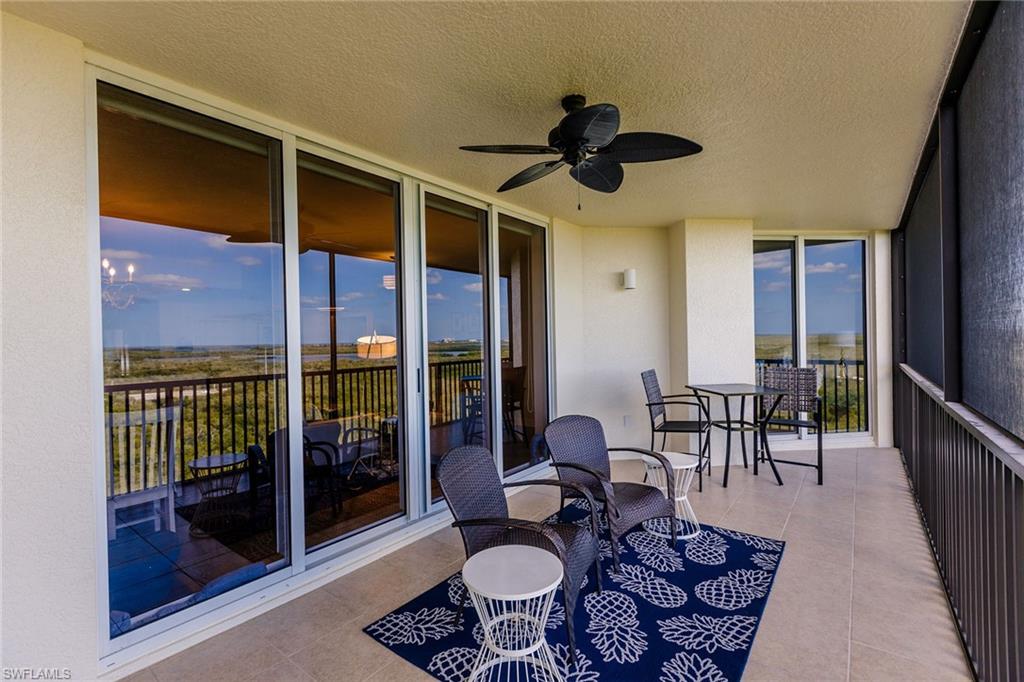 1065 Borghese Lane, Unit 1003 Naples, FL 34114 - Photo 31 of 43 a dining room with furniture and a floor to ceiling window
