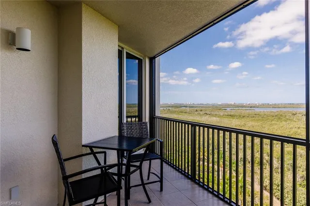 a view of a chairs and table in the balcony