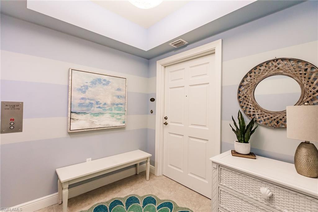 1065 Borghese Lane, Unit 1003 Naples, FL 34114 - Photo 35 of 43 a bathroom with a toilet a sink and mirror