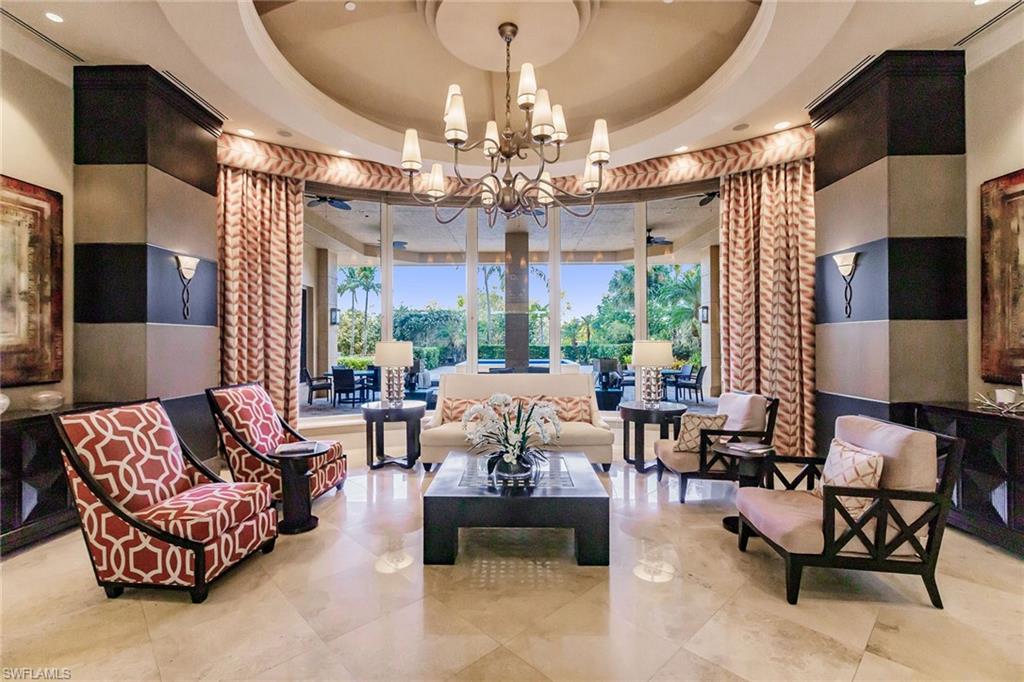 1065 Borghese Lane, Unit 1003 Naples, FL 34114 - Photo 36 of 43 a living room with patio furniture and a chandelier