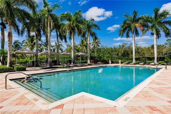 a view of swimming pool with a table and chairs