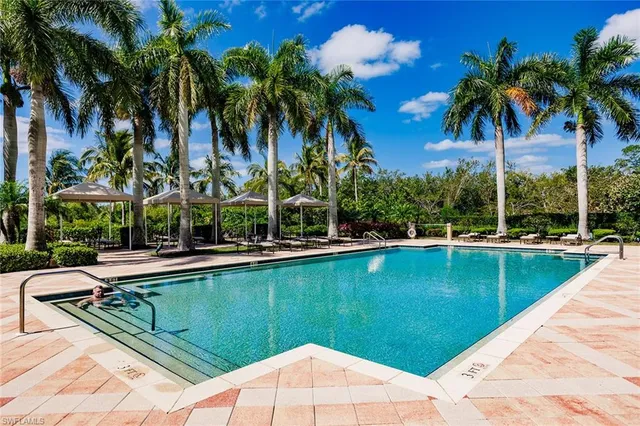 a view of swimming pool with a table and chairs