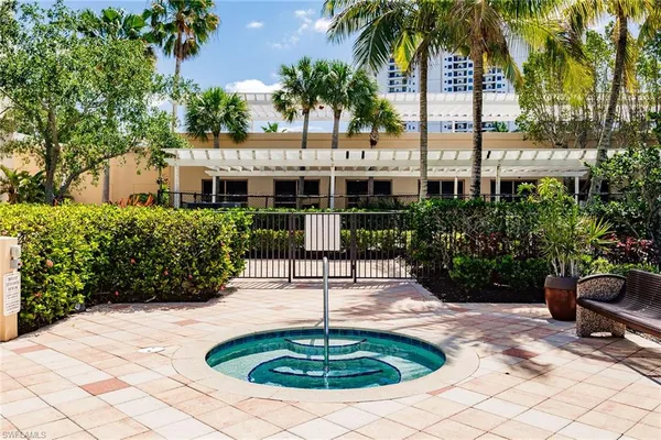 a swimming pool with outdoor seating and plants