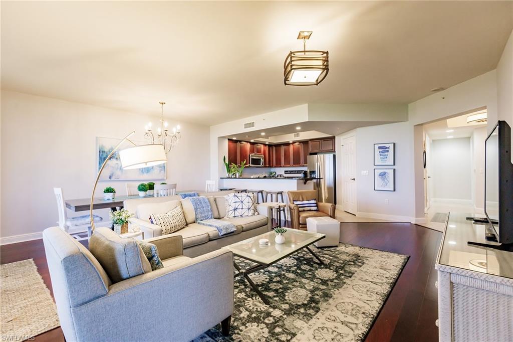 1065 Borghese Lane, Unit 1003 Naples, FL 34114 - Photo 5 of 43 a living room with furniture and a flat screen tv