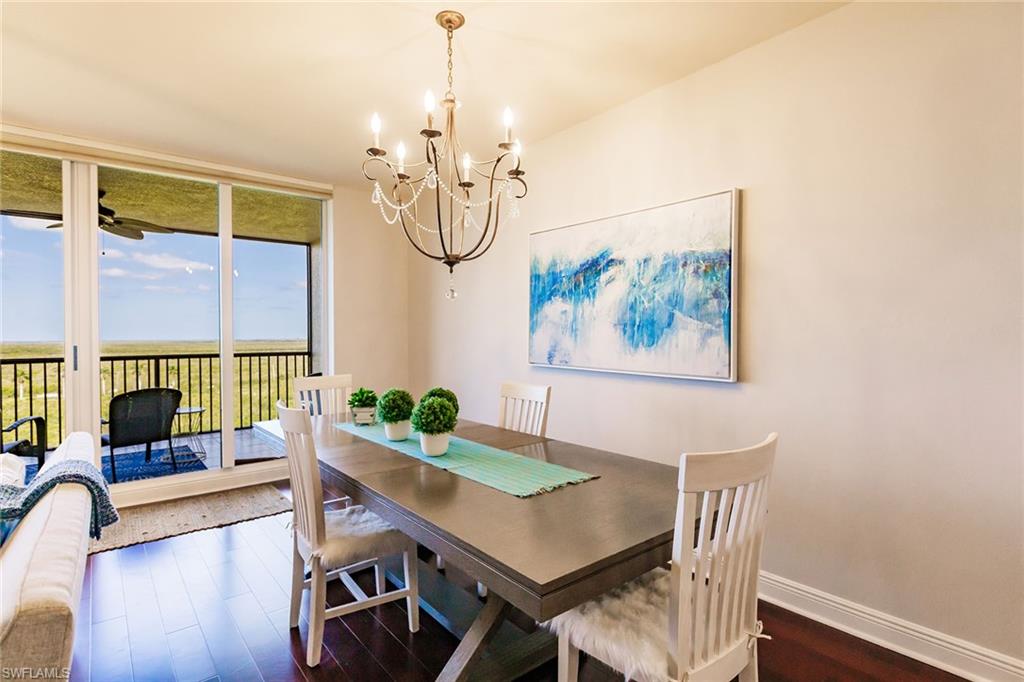 1065 Borghese Lane, Unit 1003 Naples, FL 34114 - Photo 7 of 43 a view of a livingroom with furniture window and wooden floor