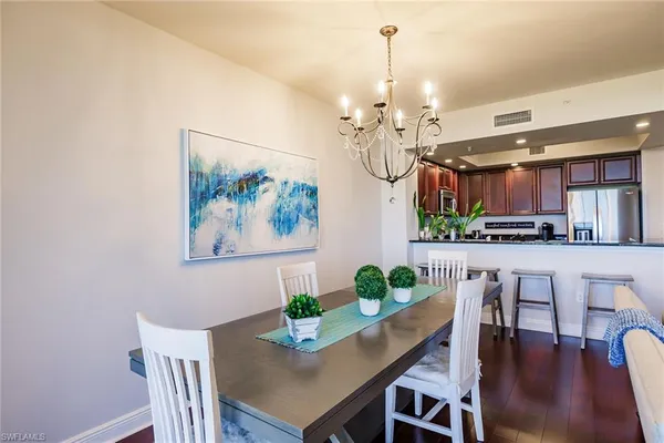 a view of a dining room with furniture kitchen and chandelier
