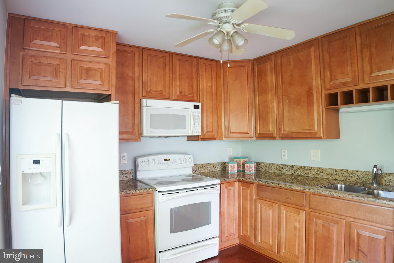 2816 Emma Lee Street, Unit 301 Falls Church, VA 22042 - Photo 17 of 45 a kitchen with stainless steel appliances granite countertop a sink a stove a refrigerator with grey cabinets