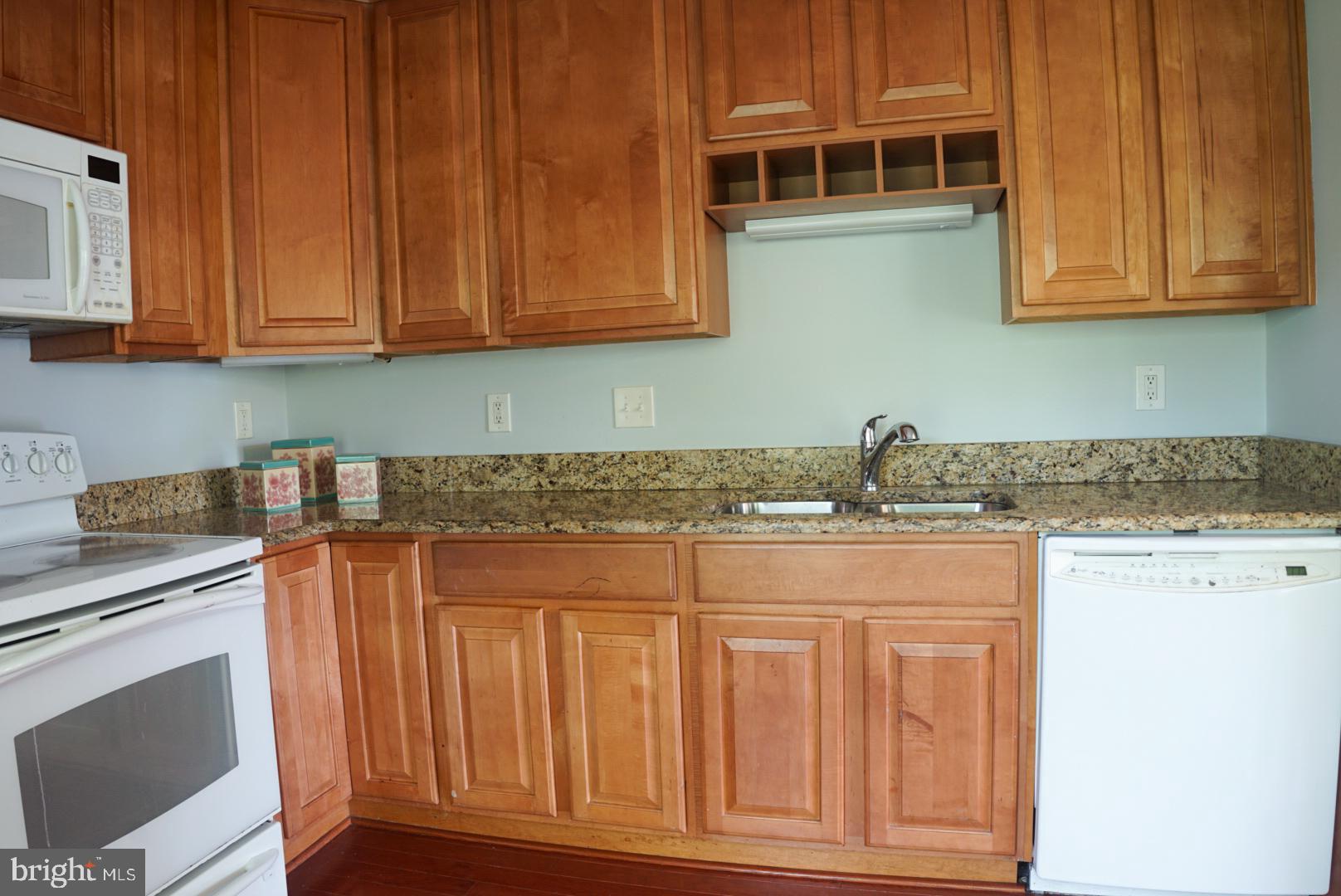 2816 Emma Lee Street, Unit 301 Falls Church, VA 22042 - Photo 18 of 45 a kitchen with stainless steel appliances granite countertop a stove a sink and a microwave