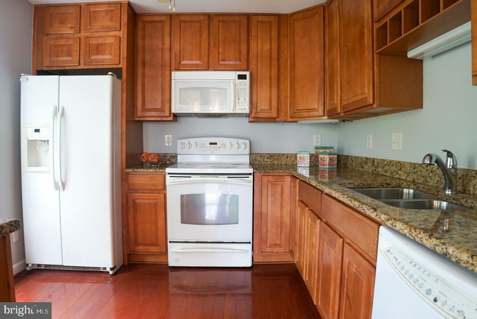 2816 Emma Lee Street, Unit 301 Falls Church, VA 22042 - Photo 19 of 45 a kitchen with stainless steel appliances granite countertop a sink stove and refrigerator
