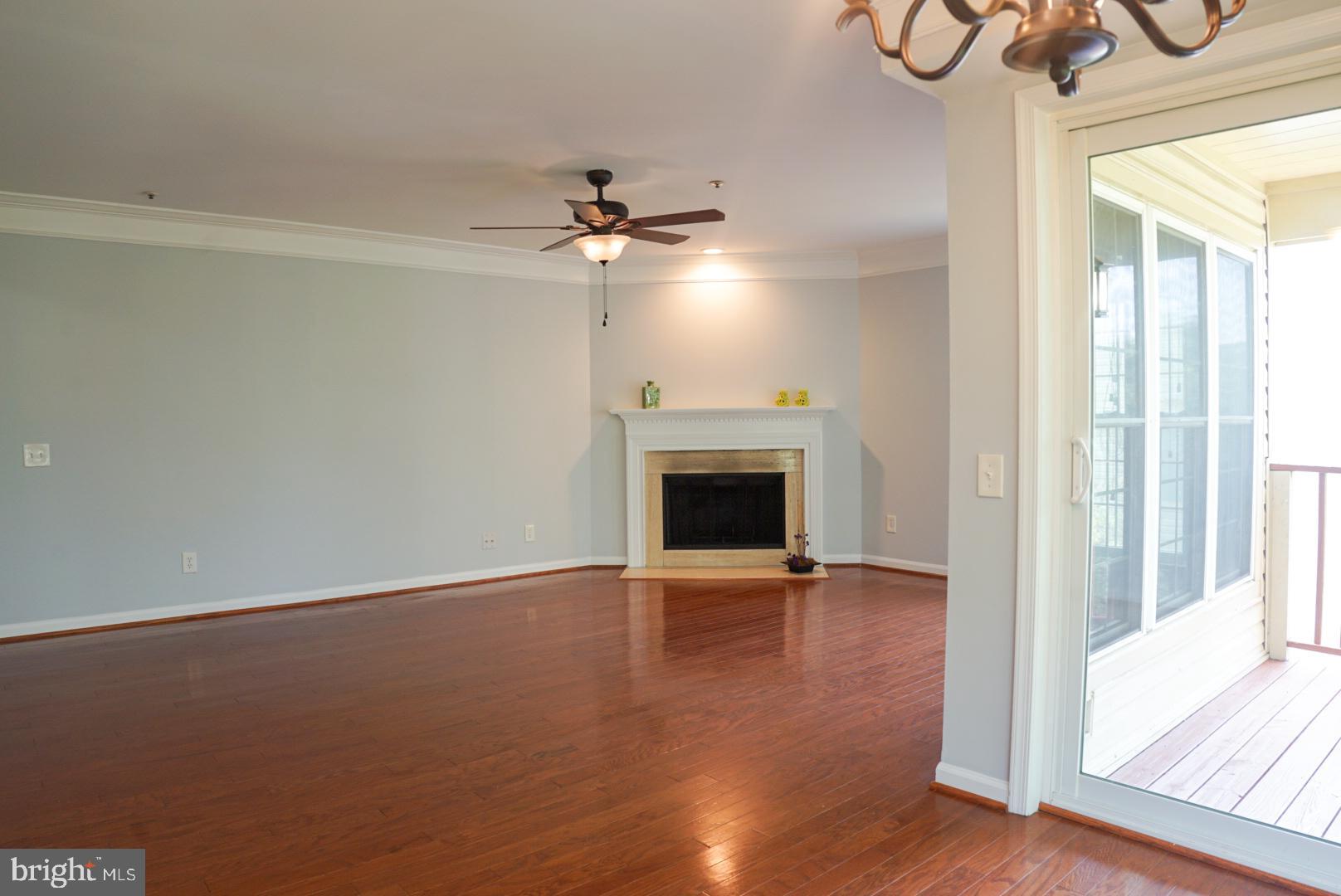 2816 Emma Lee Street, Unit 301 Falls Church, VA 22042 - Photo 2 of 45 a view of an empty room with a fireplace and a window