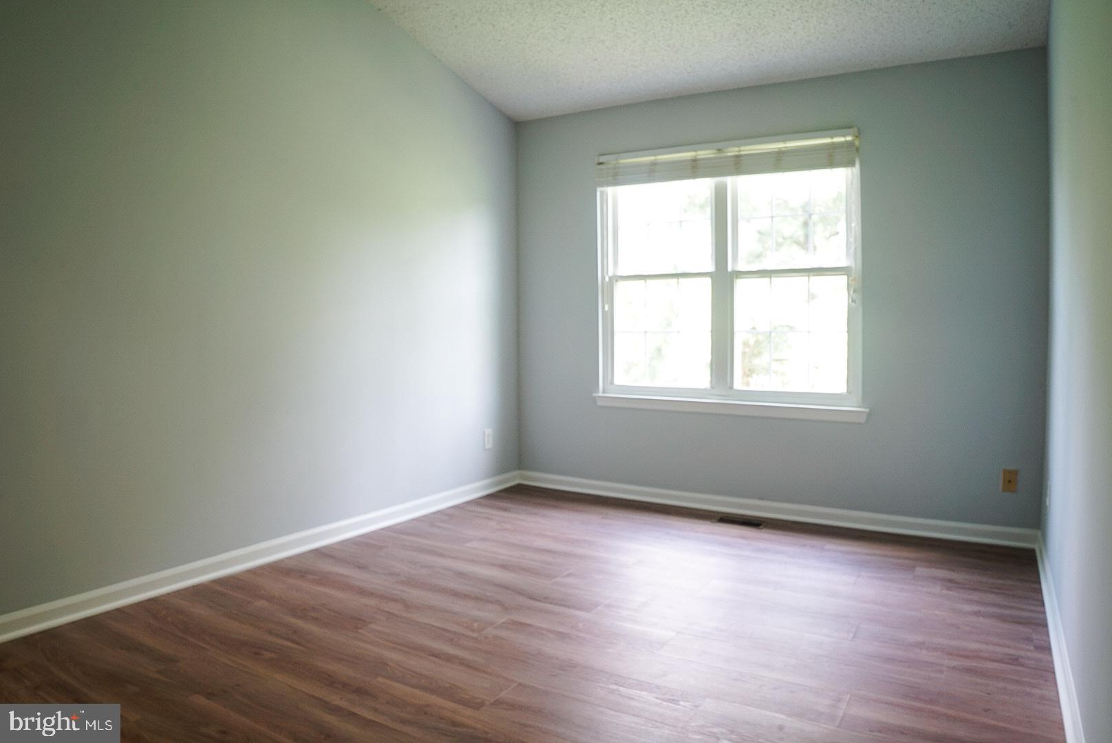 2816 Emma Lee Street, Unit 301 Falls Church, VA 22042 - Photo 23 of 45 an empty room with wooden floor and windows