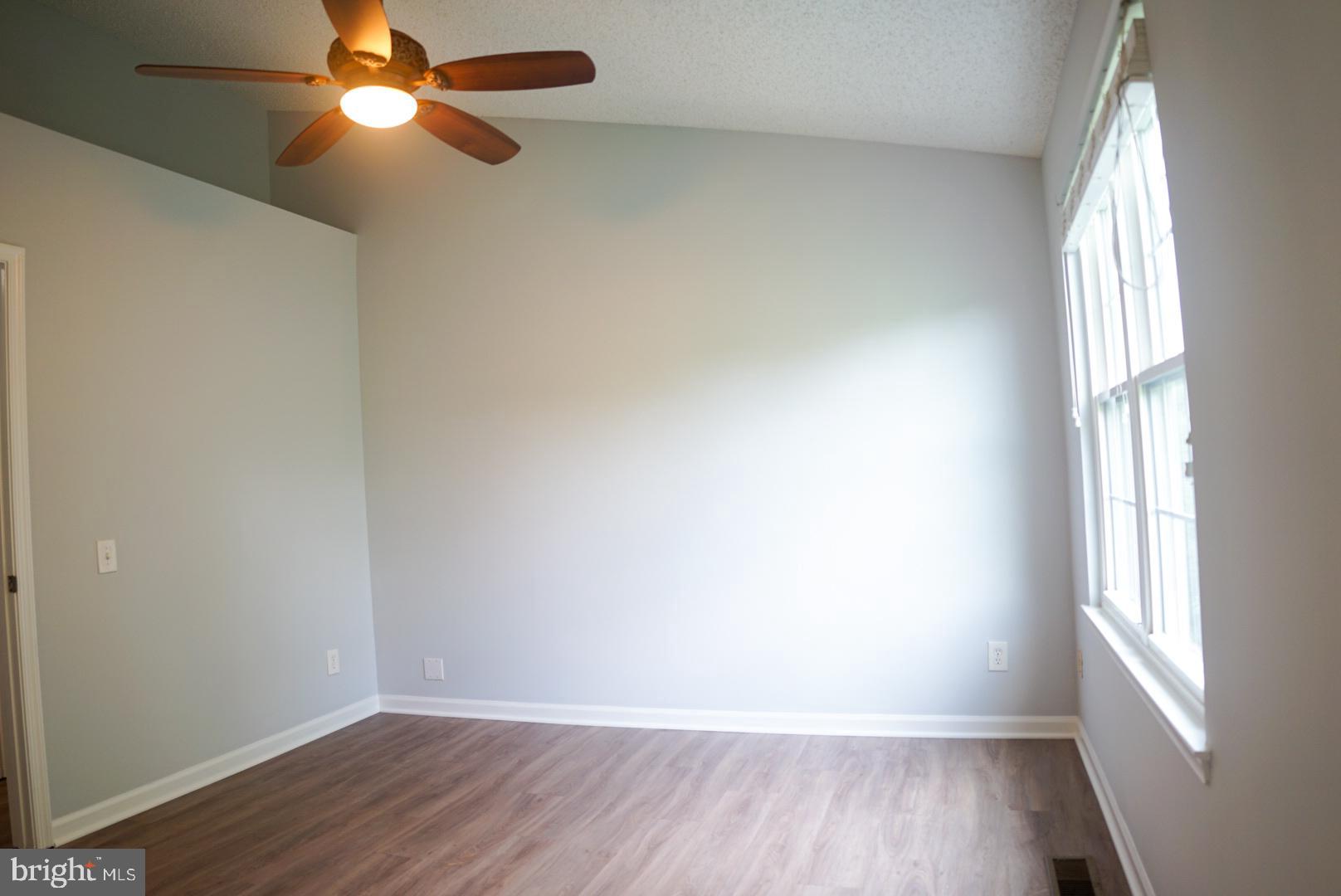 2816 Emma Lee Street, Unit 301 Falls Church, VA 22042 - Photo 24 of 45 an empty room with wooden floor fan and windows
