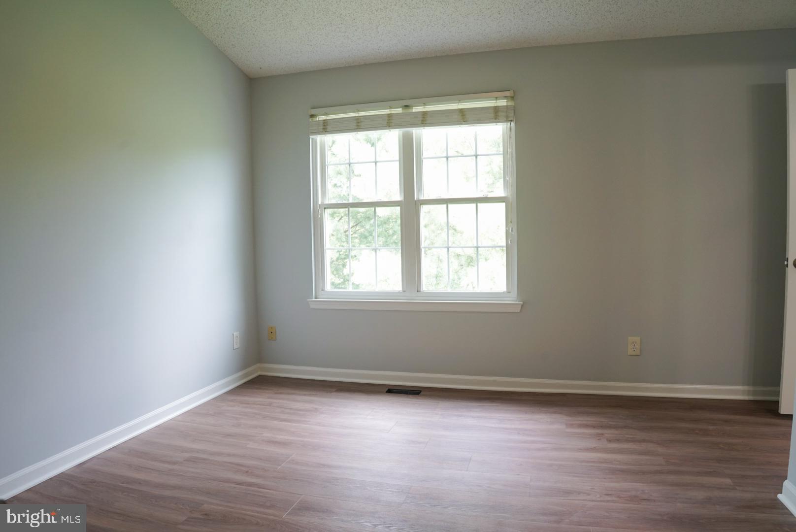 2816 Emma Lee Street, Unit 301 Falls Church, VA 22042 - Photo 25 of 45 an empty room with wooden floor and windows