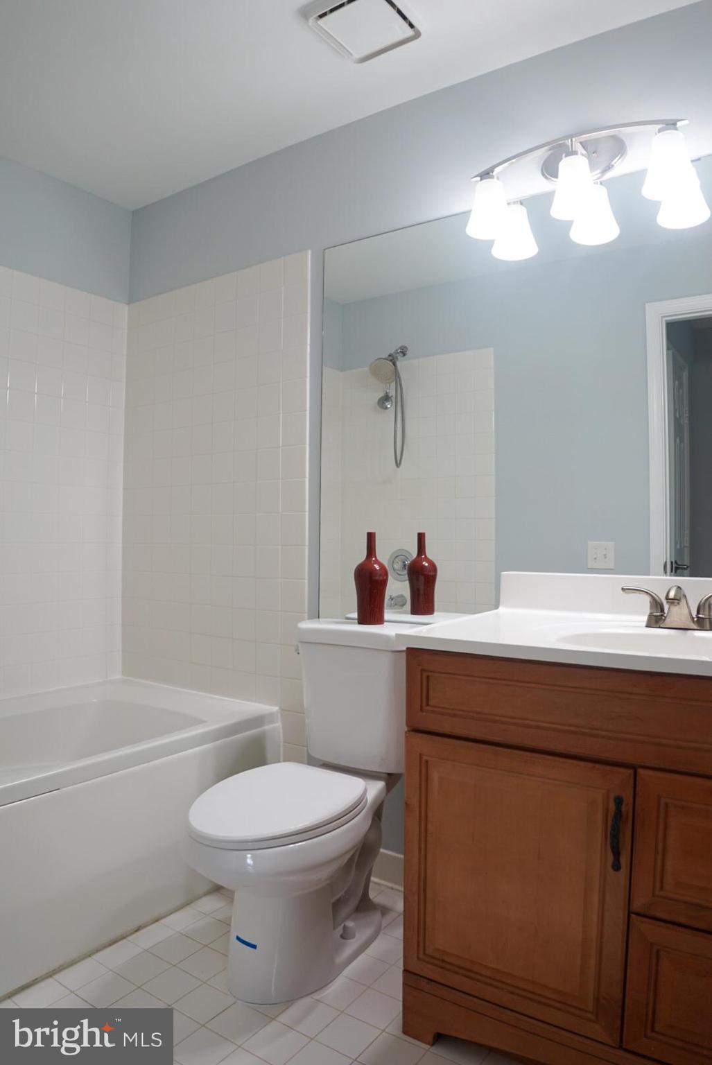 2816 Emma Lee Street, Unit 301 Falls Church, VA 22042 - Photo 28 of 45 a bathroom with a toilet a sink and mirror