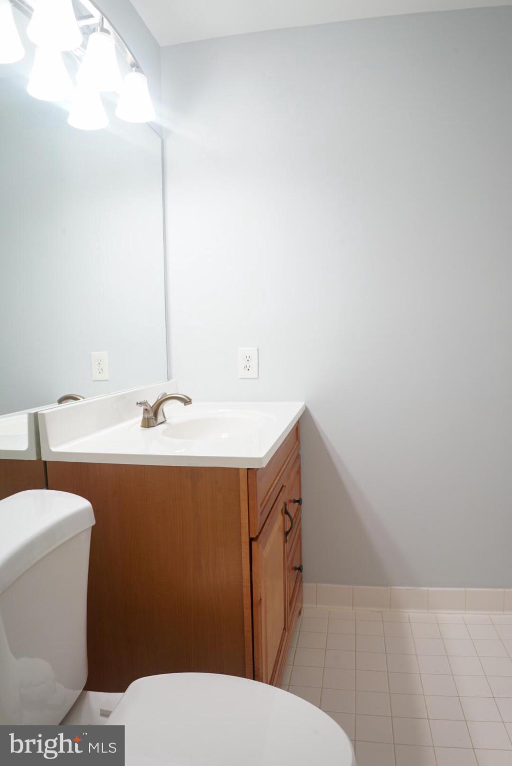 2816 Emma Lee Street, Unit 301 Falls Church, VA 22042 - Photo 32 of 45 a bathroom with a sink a toilet and a mirror
