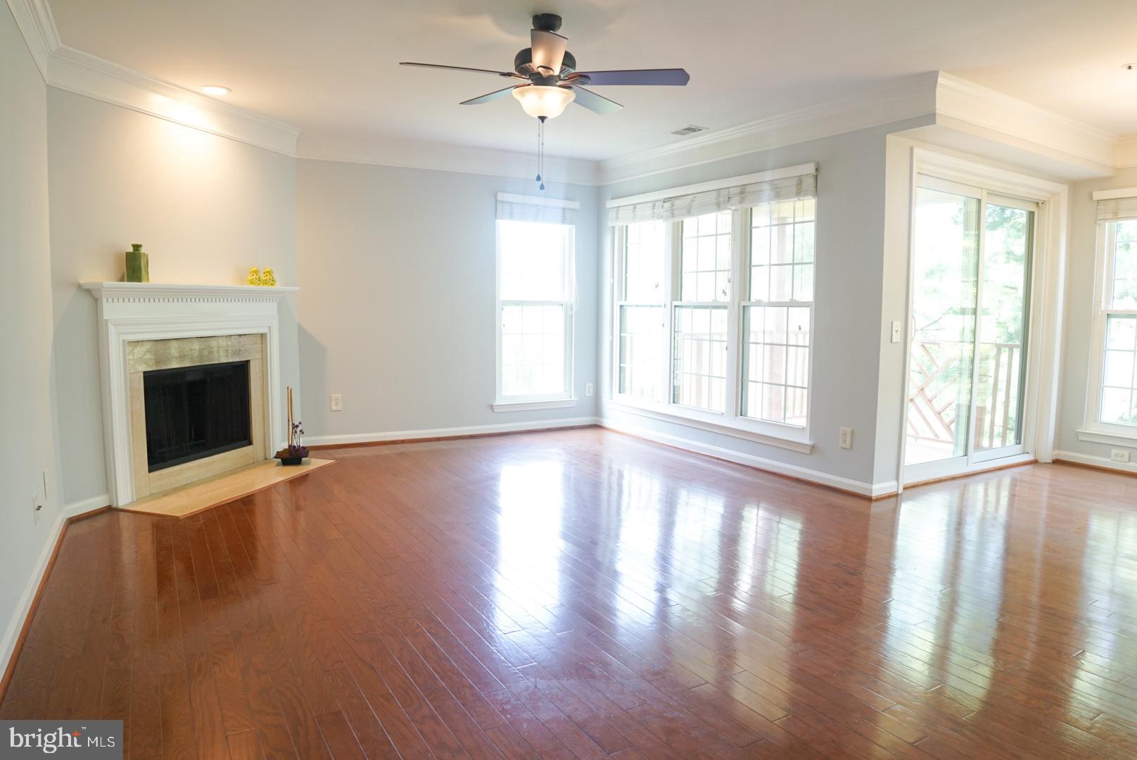 2816 Emma Lee Street, Unit 301 Falls Church, VA 22042 - Photo 10 of 45 a view of an empty room with wooden floor and a fireplace