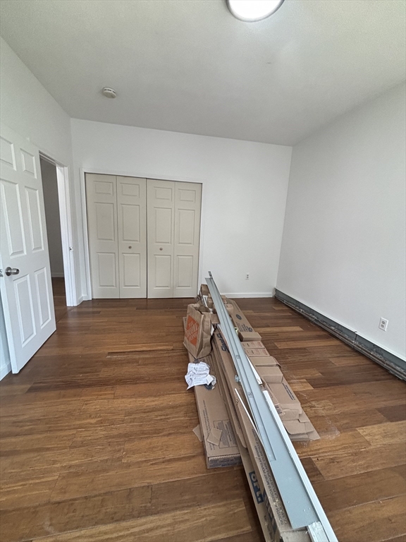 39 Shawmut Street, Unit 1 Chelsea, MA 02150 - Photo 13 of 13 a room with wooden floor and white walls