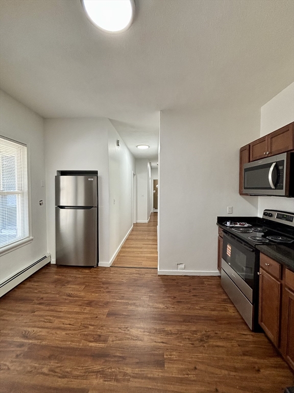 39 Shawmut Street, Unit 1 Chelsea, MA 02150 - Photo 2 of 13 a view of a kitchen with a sink and a stove