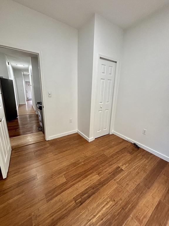 39 Shawmut Street, Unit 1 Chelsea, MA 02150 - Photo 4 of 13 a view of a livingroom with wooden floor and flat screen tv