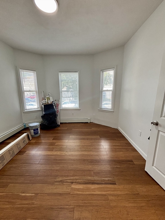 39 Shawmut Street, Unit 1 Chelsea, MA 02150 - Photo 9 of 13 an empty room with wooden floor and windows
