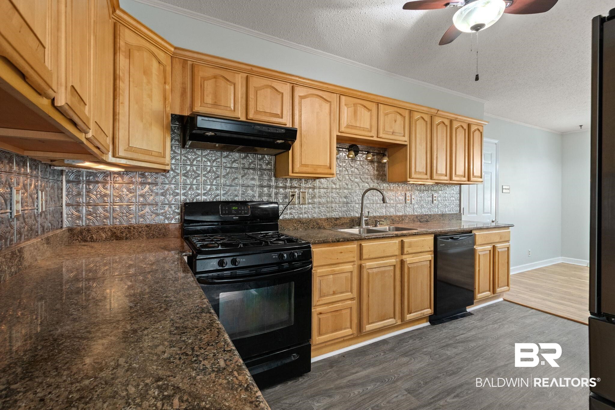 3864 Leroy Stevens Road Mobile, AL 36619 - Photo 10 of 33 Kitchen with black appliances, crown molding, a textured ceiling, ceiling fan, and dark wood finished floors