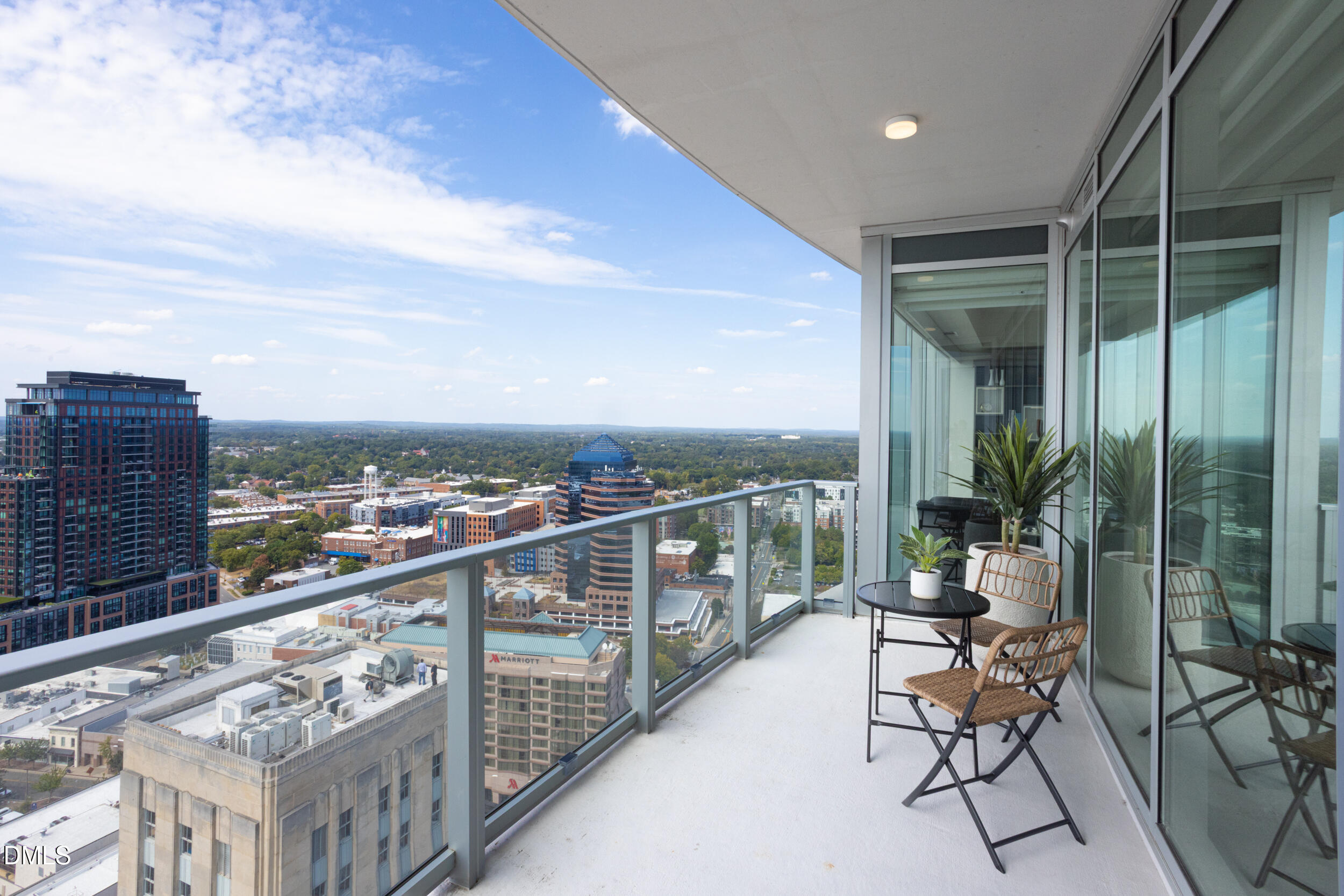 110 Corcoran Street, Unit 2502 Durham, NC 27701 - Photo 48 of 87 a view of a balcony with chairs and a table