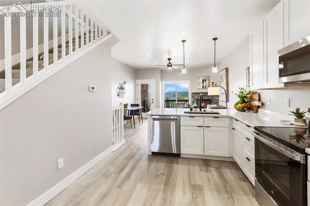 a kitchen with a sink stove and microwave