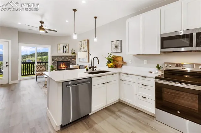 a kitchen with stainless steel appliances a stove refrigerator sink and cabinets