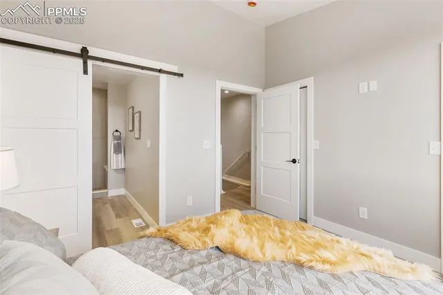 a view of a hallway with wooden floor and entryway