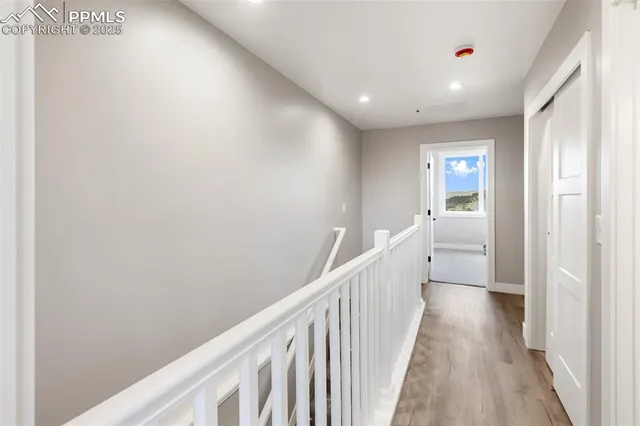 a view of a hallway to rooms