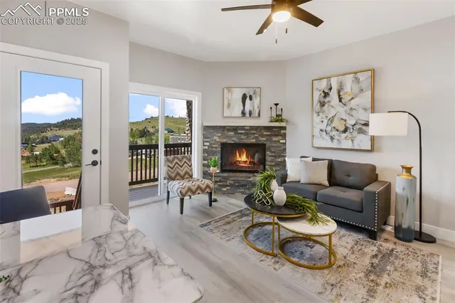a view of a kitchen with furniture and wooden floor