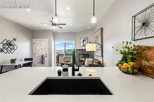 a kitchen with a sink a counter space appliances and cabinets