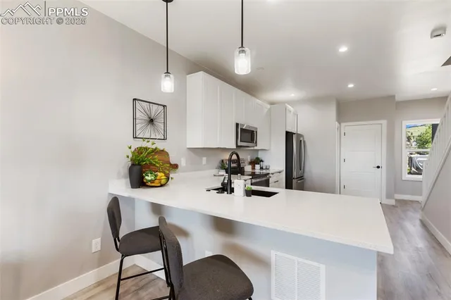 a living room with dining table furniture and a chandelier