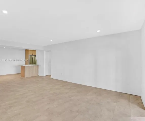 a view of an empty room with closet and closet