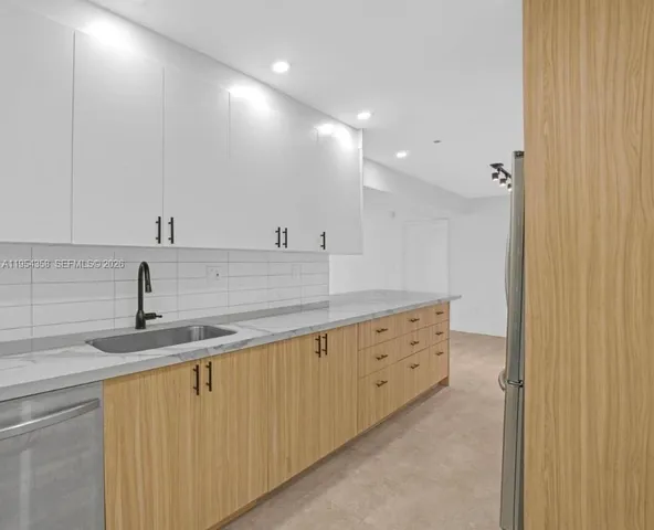 a kitchen with cabinets a sink and dishwasher