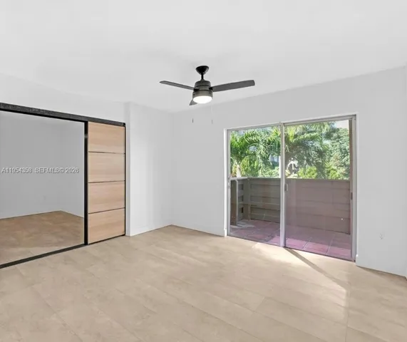 an empty room with windows and closet