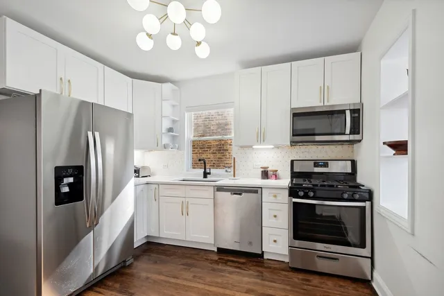 a kitchen with a sink stainless steel appliances and cabinets
