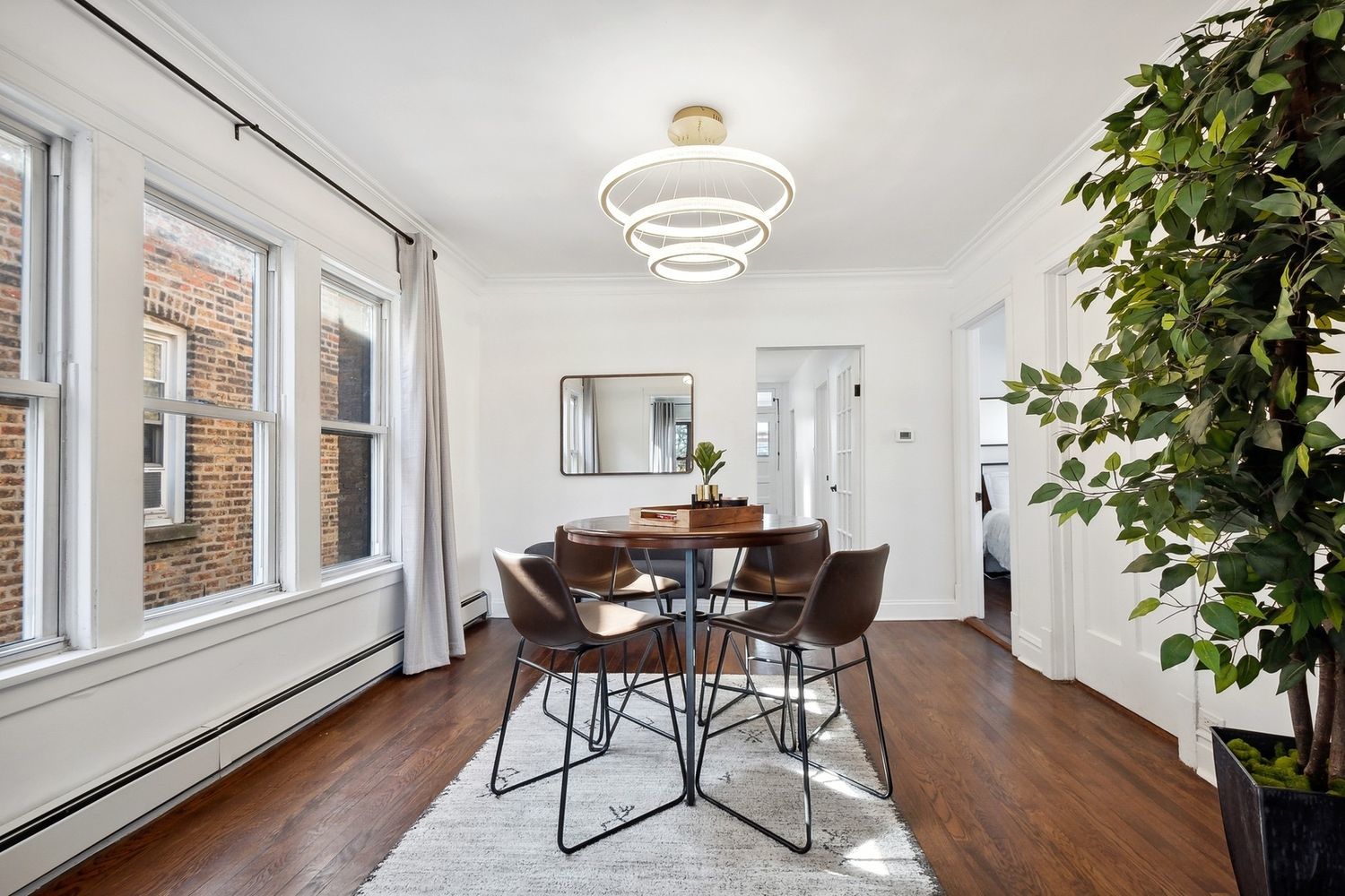 5426 North Western Avenue, Unit 2 Chicago, IL 60625 - Photo 5 of 10 a view of a dining room with furniture window and wooden floor