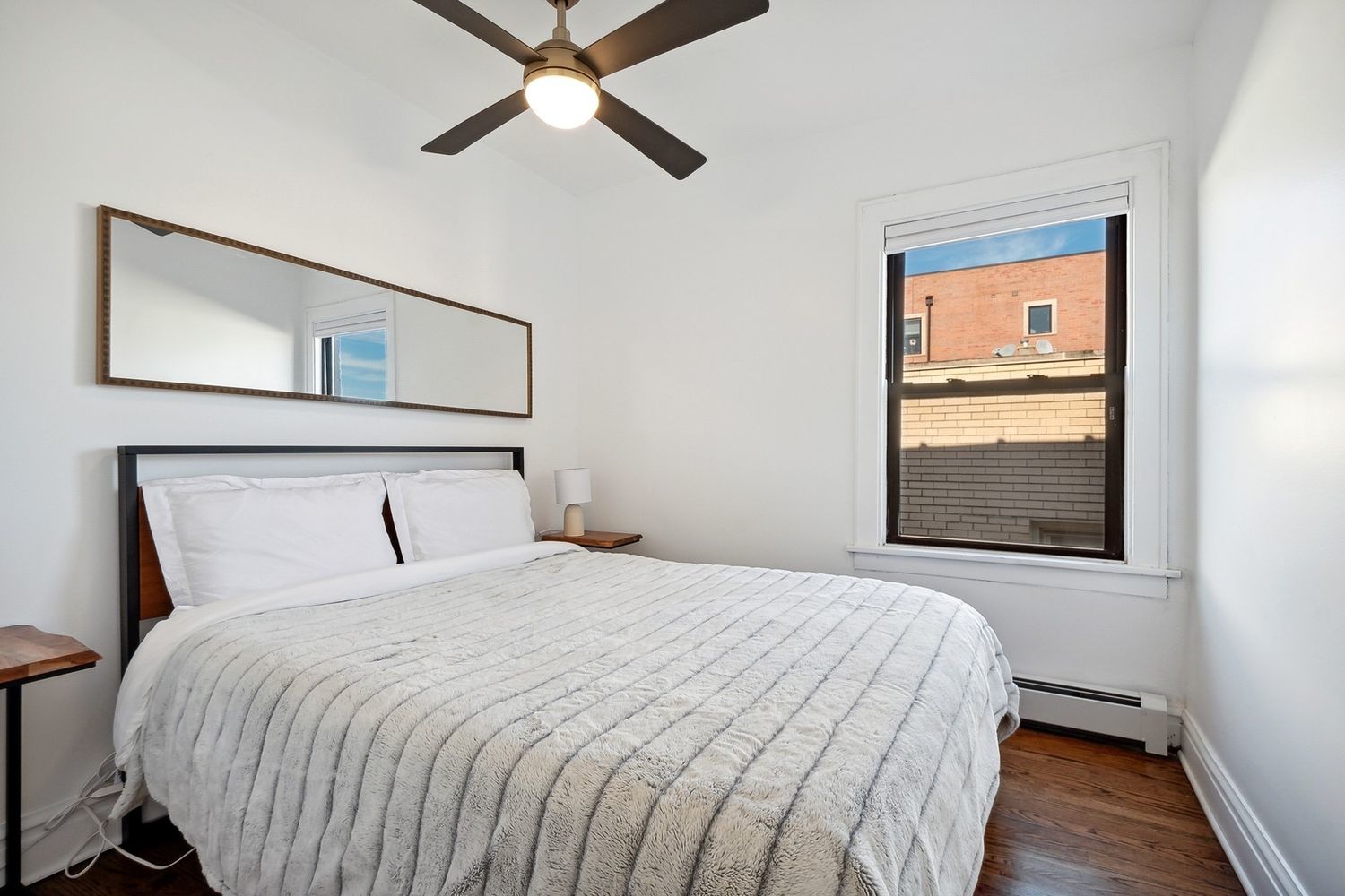5426 North Western Avenue, Unit 2 Chicago, IL 60625 - Photo 6 of 10 a bedroom with a bed and a painting on the wall