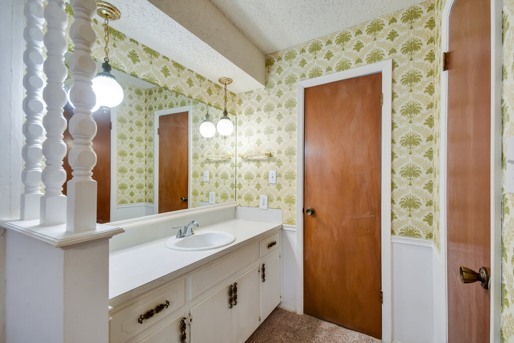301 Navajo Trail Georgetown, TX 78633 - Photo 30 of 35 Bathroom featuring wallpapered walls, a textured ceiling, and vanity