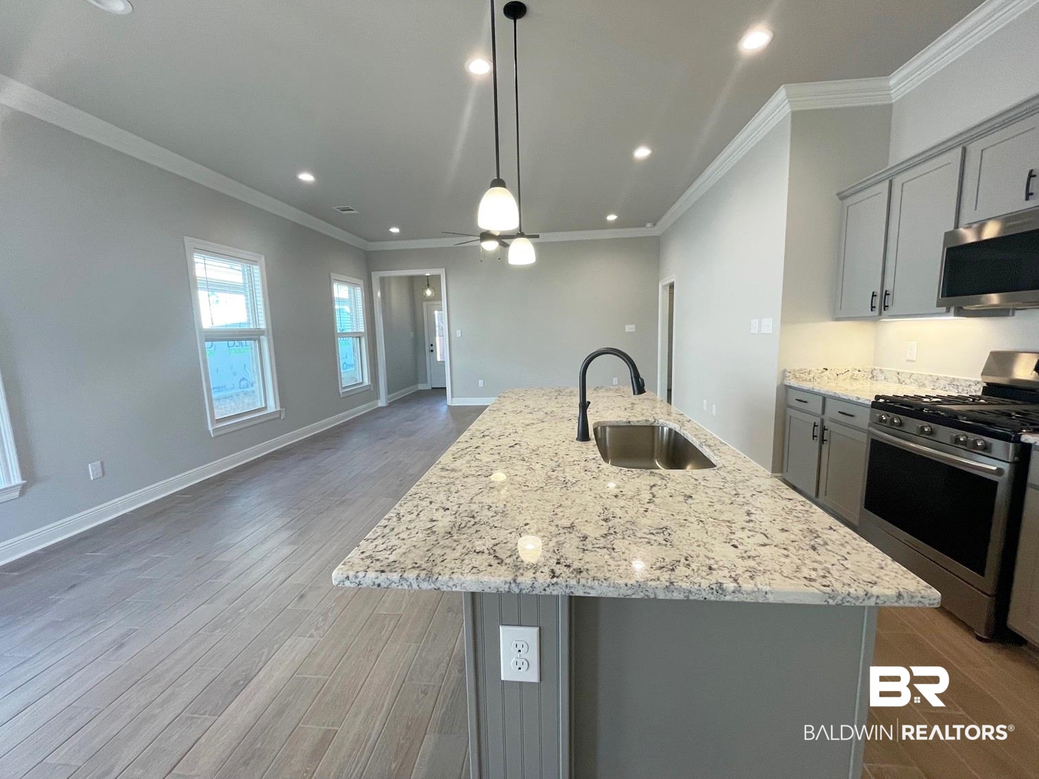 1355 Fenton Circle Foley, AL 36535 - Photo 4 of 17 Kitchen with gray cabinetry, a kitchen island with sink, and appliances with stainless steel finishes