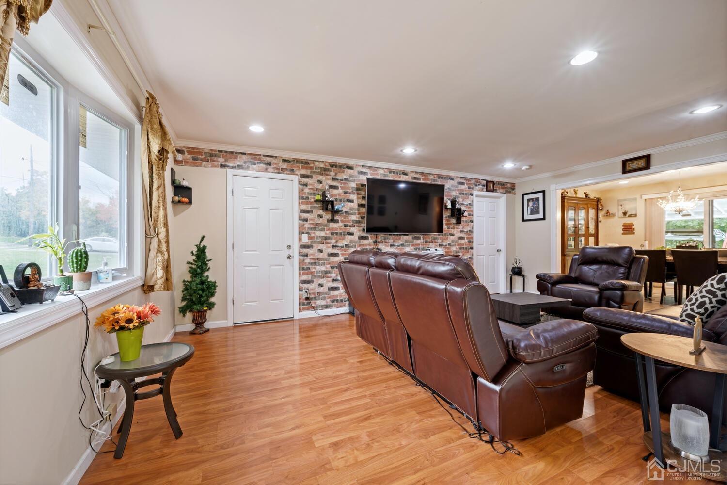 21 Kingsley Road Kendall Park, NJ 08824 - Photo 7 of 29 a living room with furniture a fireplace and a flat screen tv