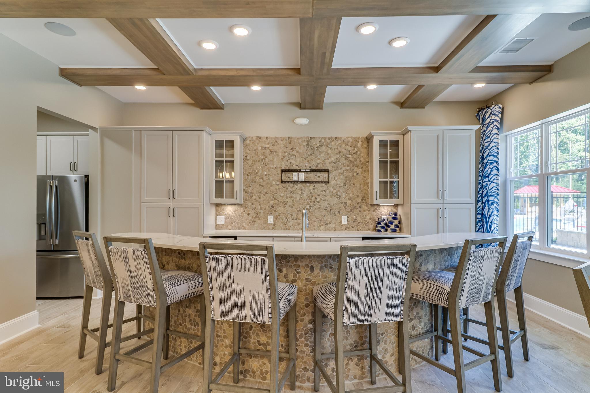 15 Golden Raintree Court Middletown, DE 19709 - Photo 12 of 25 a kitchen with stainless steel appliances kitchen island granite countertop a dining table chairs and granite counter tops