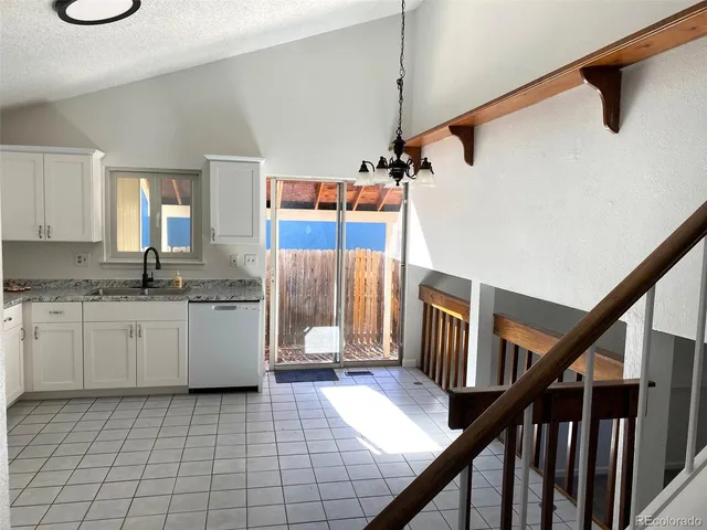 a open kitchen with cabinets a sink and appliances
