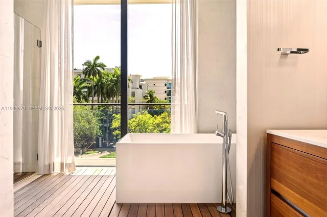 a room with a balcony a bed and a window with outer view