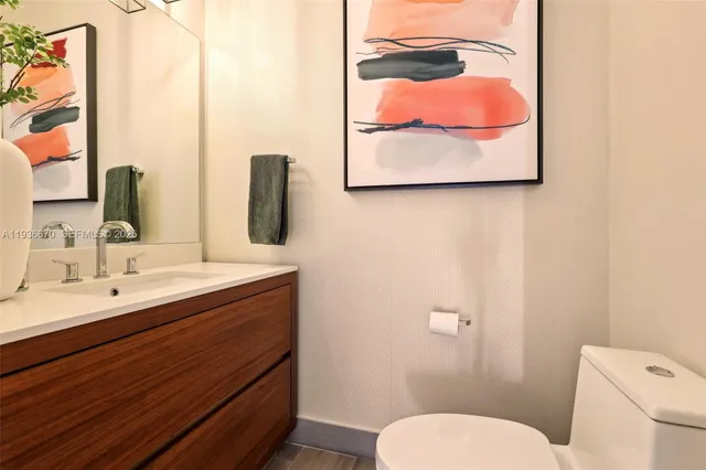 a bathroom with a toilet sink and mirror